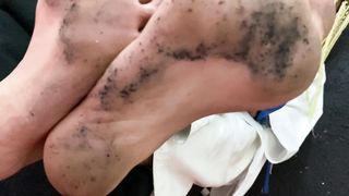 A slave licks the feet of a karate girl after training