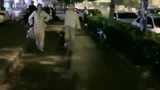 Chinese mistress feeding her dog in public