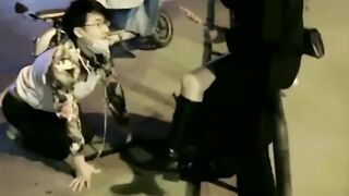 Chinese mistress feeding her dog in public