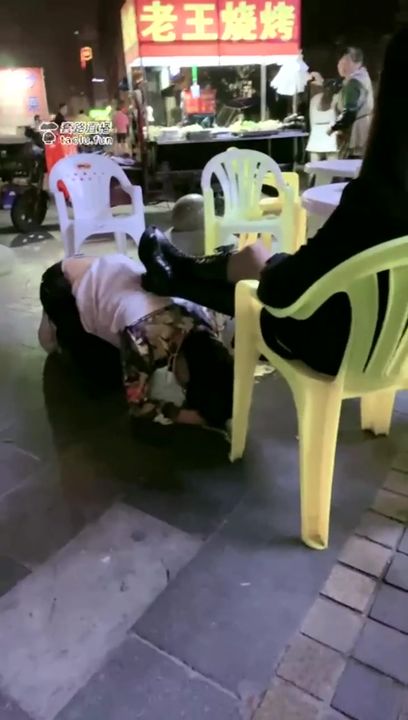 Chinese mistress feeding her dog in public