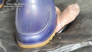 Extreme Ball Stomping and Trampling with abused red and blue rubber boots on cock board