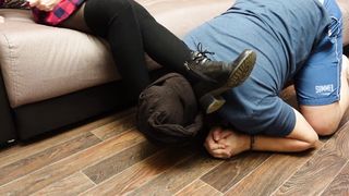 A Slave in Handcuffs and a Collar Licks the Shoes of a Mistress in Black Tights and Socks