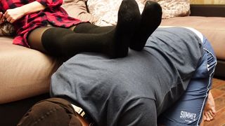 A Slave in a Collar is Kneeling Legs in Black Socks and Tights