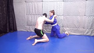Girl wearing gi wrestling older guy
