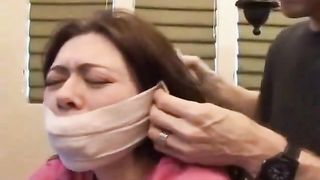 Bound and tape gagged slut gets fucked on the table