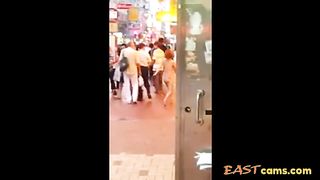 Asian woman stripped naked on street