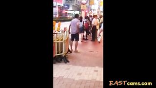 Asian woman stripped naked on street