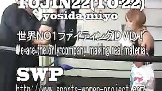 Asian girl boxes and kicks male opponent