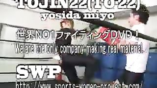 Asian girl boxes and kicks male opponent