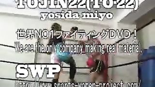 Asian girl boxes and kicks male opponent