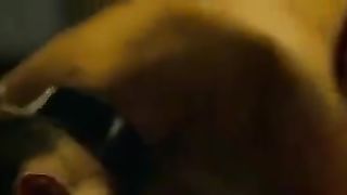 White dominatrix dominating Indian man on bed