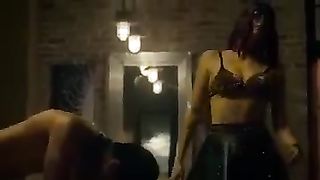 White dominatrix dominating Indian man on bed